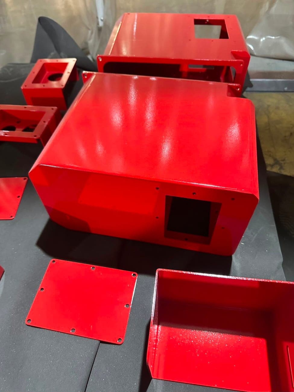 Red coated fabricated metal enclosures and panels