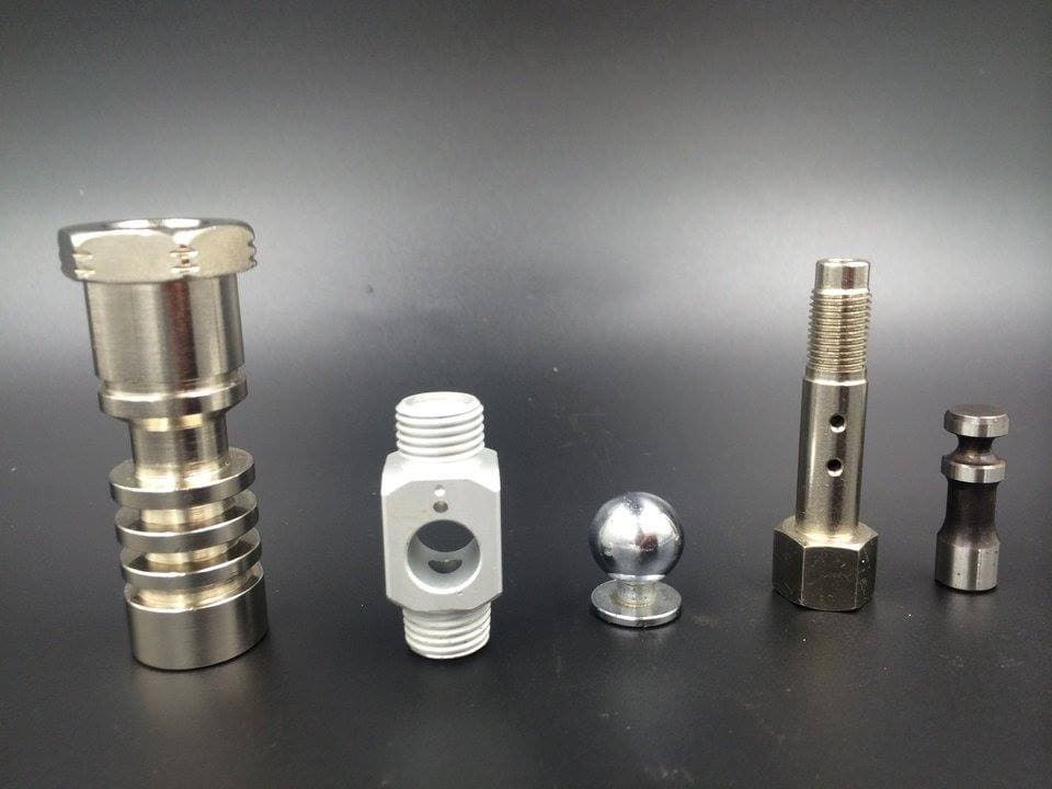 Machined components with threads, grooves, cross-holes and a spherical feature