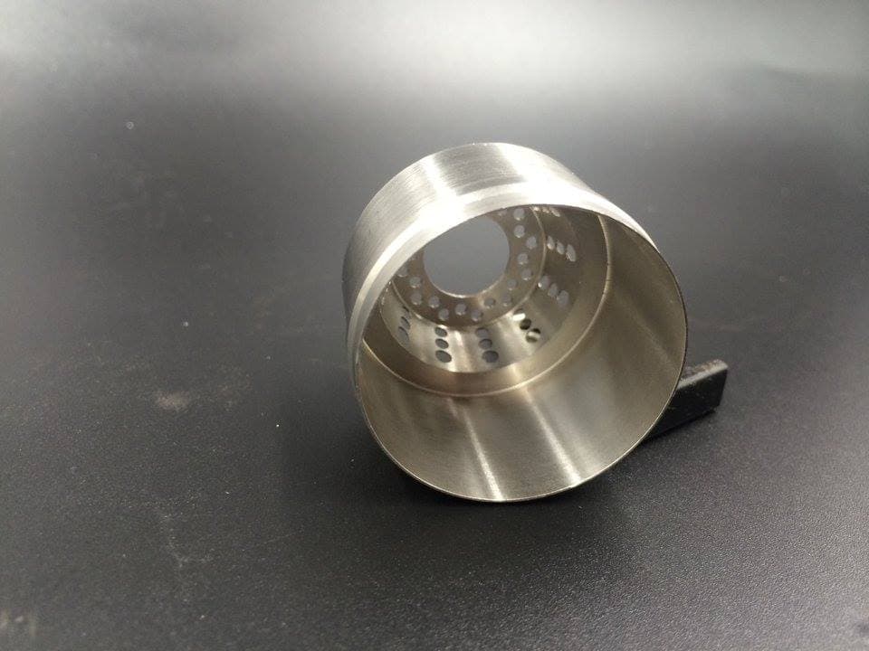 Cup-shaped machined component with internal bores and a circular hole pattern
